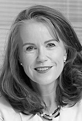 A close-up portrait of Dr Lisa O'Brien, Chair of AERO, who has shoulder length wavy hair and is smiling.