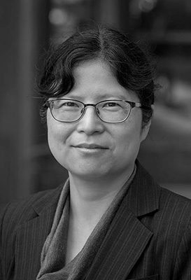 A cropped, close-up black and white portrait of Dr Lucy Lu, Senior Manager, Analytics and Strategic Projects