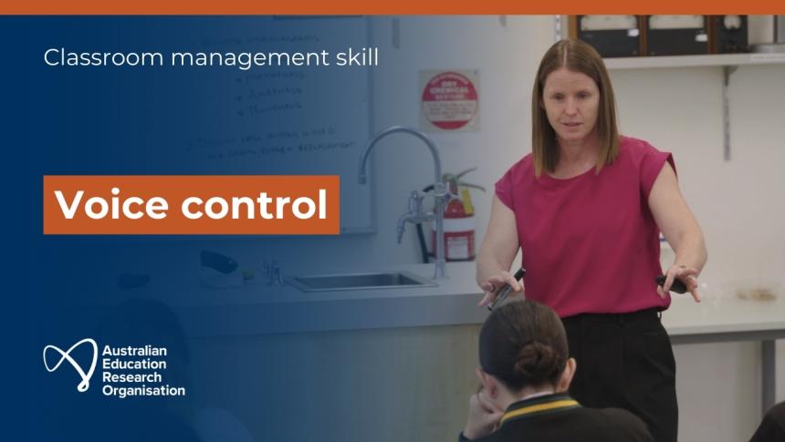 A screenshot from the video showing a teacher talking in front of a class of students. 